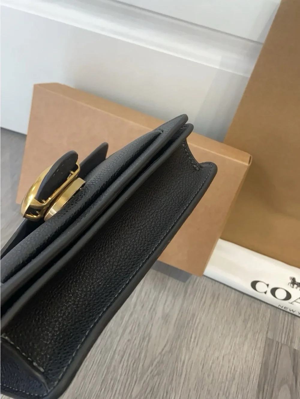 Coach Black Leather Crossbody with Gold 'C' Hardware and Chain Strap